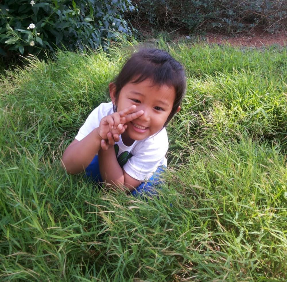 Playing in the grass as a young child