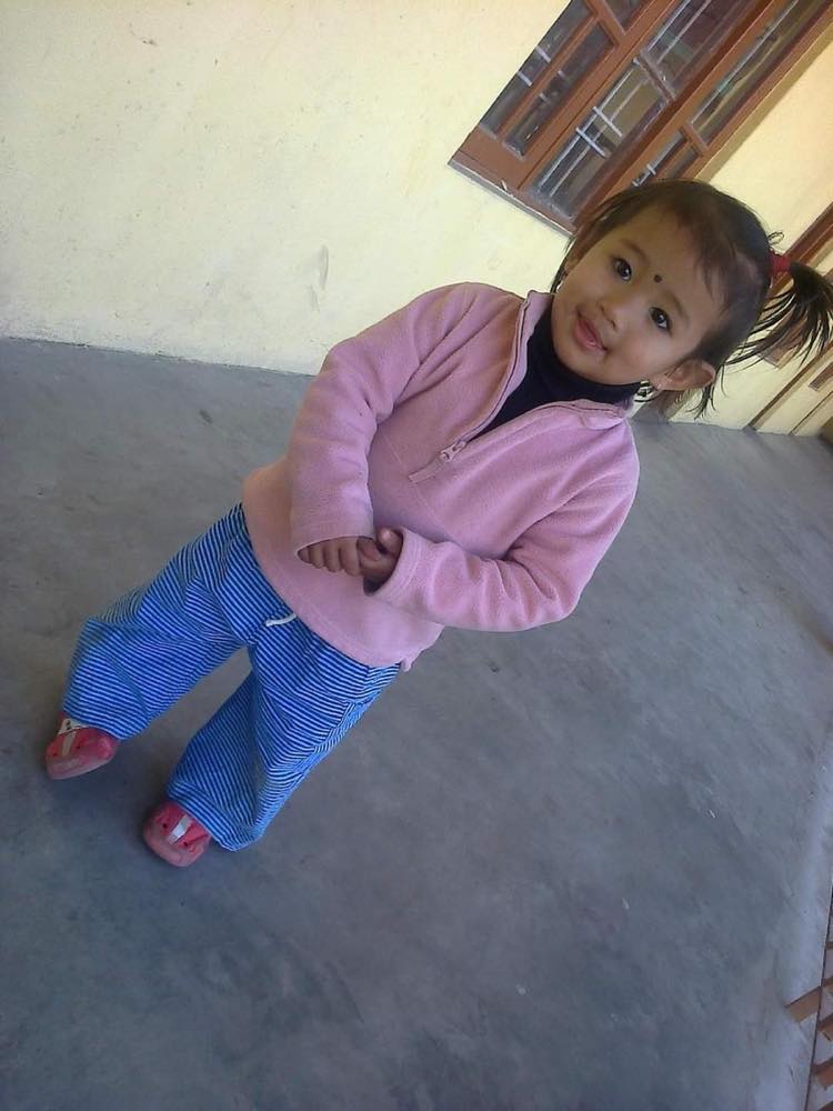 A little girl in a pink jacket, growing up in his care