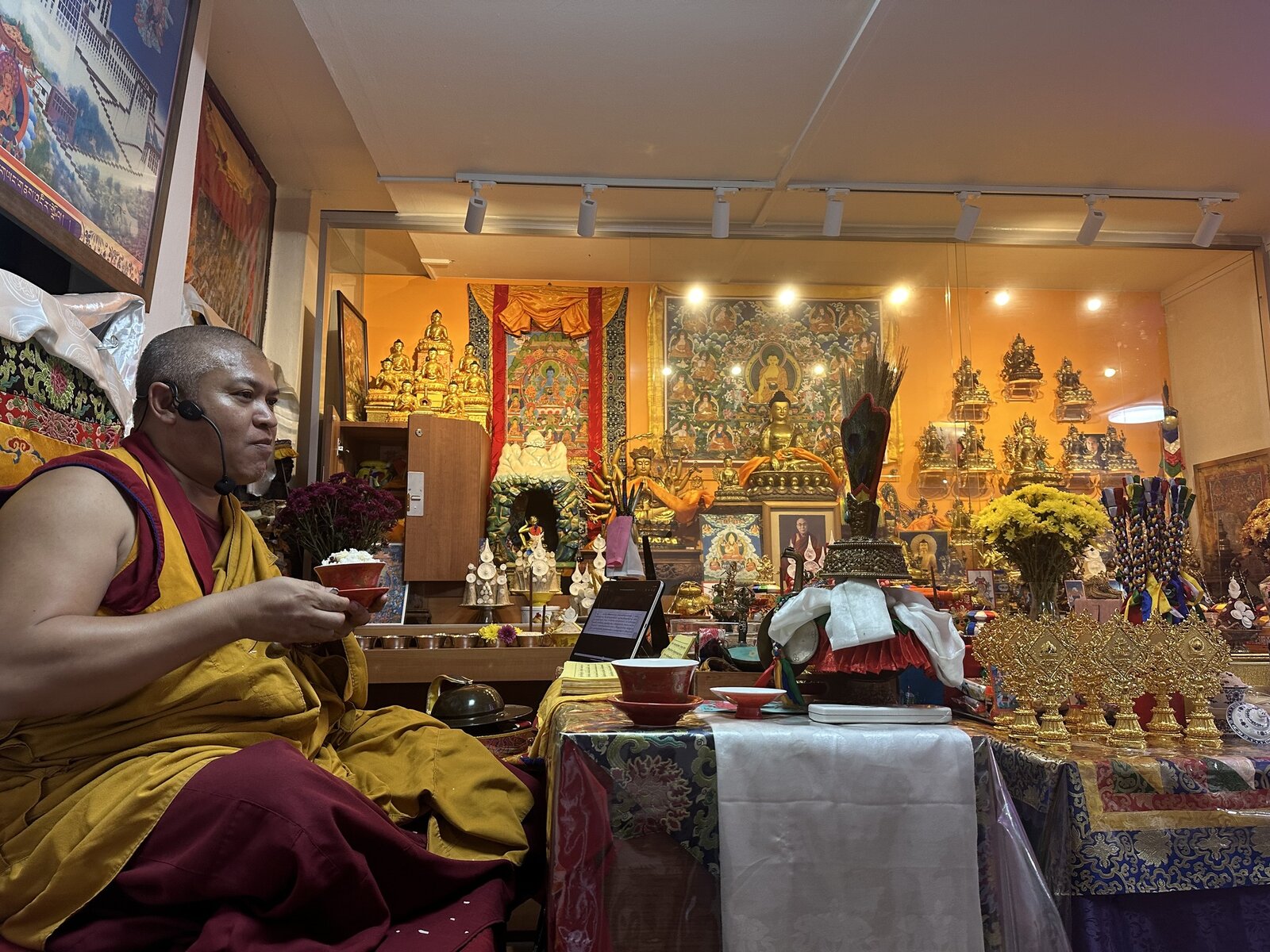 The lama performing puja at the Tashi Gephelling Buddhist Centre altar